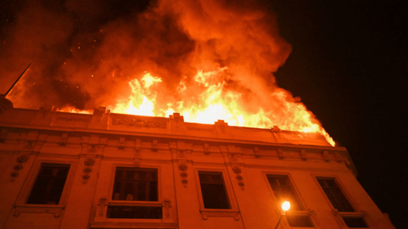 Thousands march toward the capital of Peru as violence grows and a building is set on fire